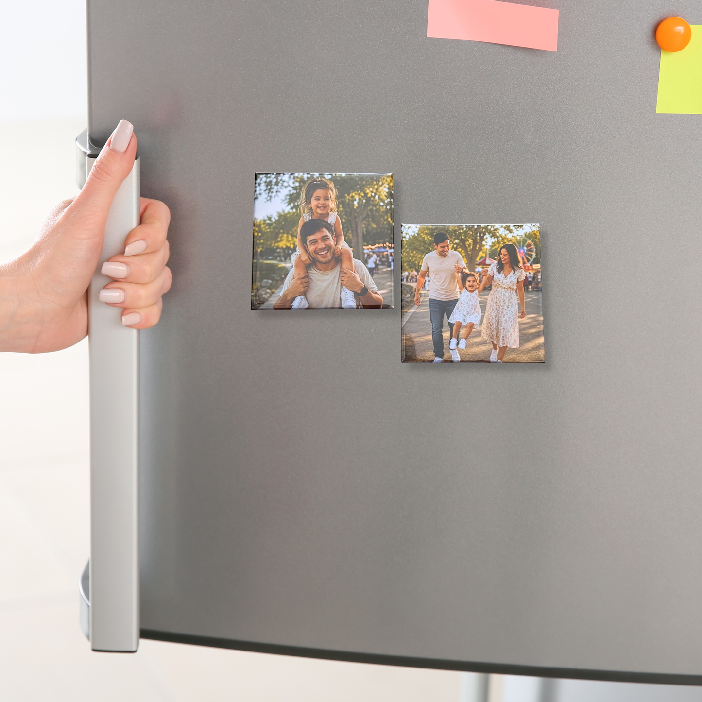 Hand opening a refrigerator door with a Signature Magnet Set displayed on it
