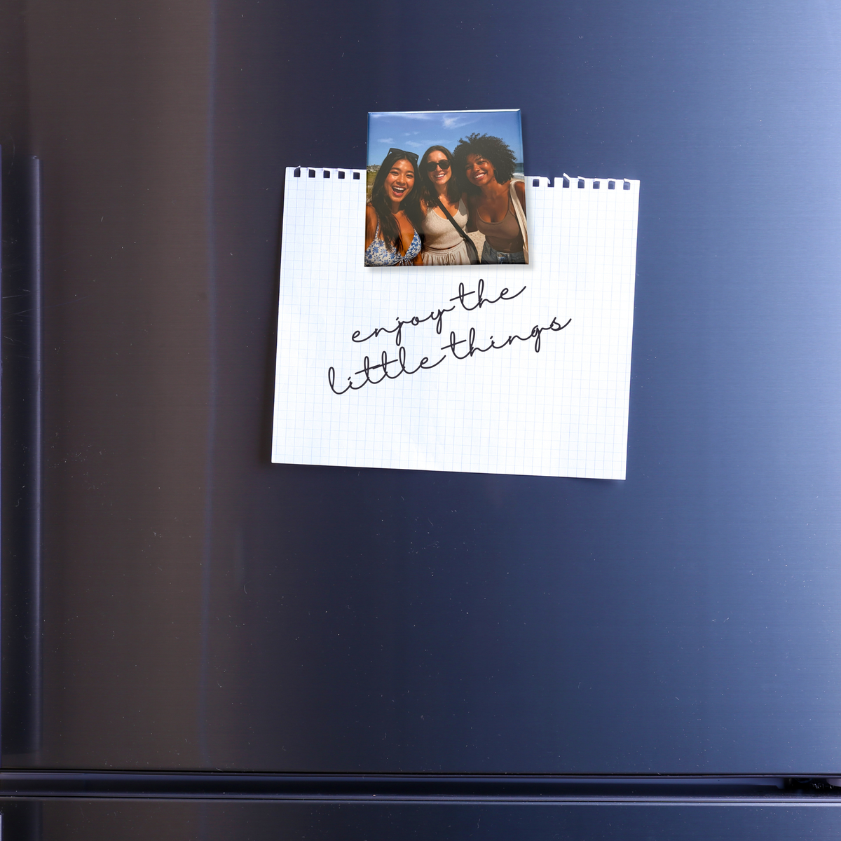 Signature Photo Magnet holding a note on a refrigerator door